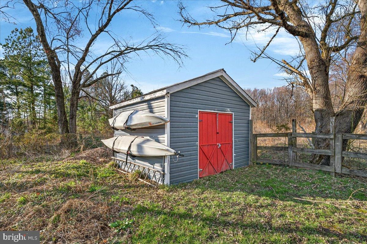 2505 West Denneys Road Dover, DE 19904 - Photo 59 of 68 Charming shed with kayaks in serene setting.