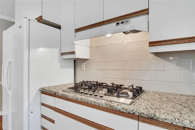 a kitchen with a stove and a shower