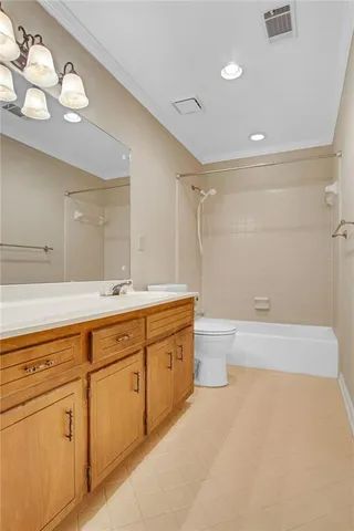 a bathroom with a granite countertop sink a toilet and bathtub