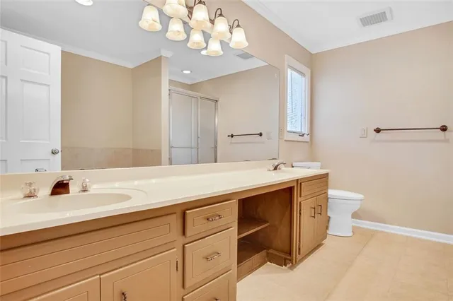 a bathroom with a sink a large mirror and a light fixture