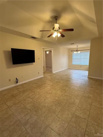 a view of a big room with wooden floor and windows