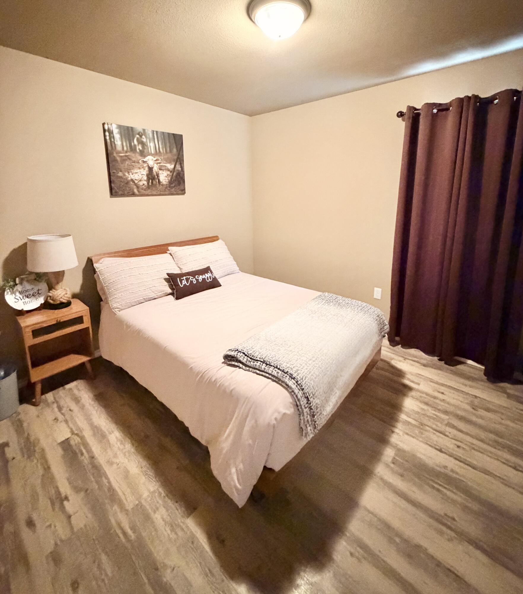 3211 East 5th Street Lubbock, TX 79403 - Photo 4 of 11 a bedroom with a bed and a painting on the wall