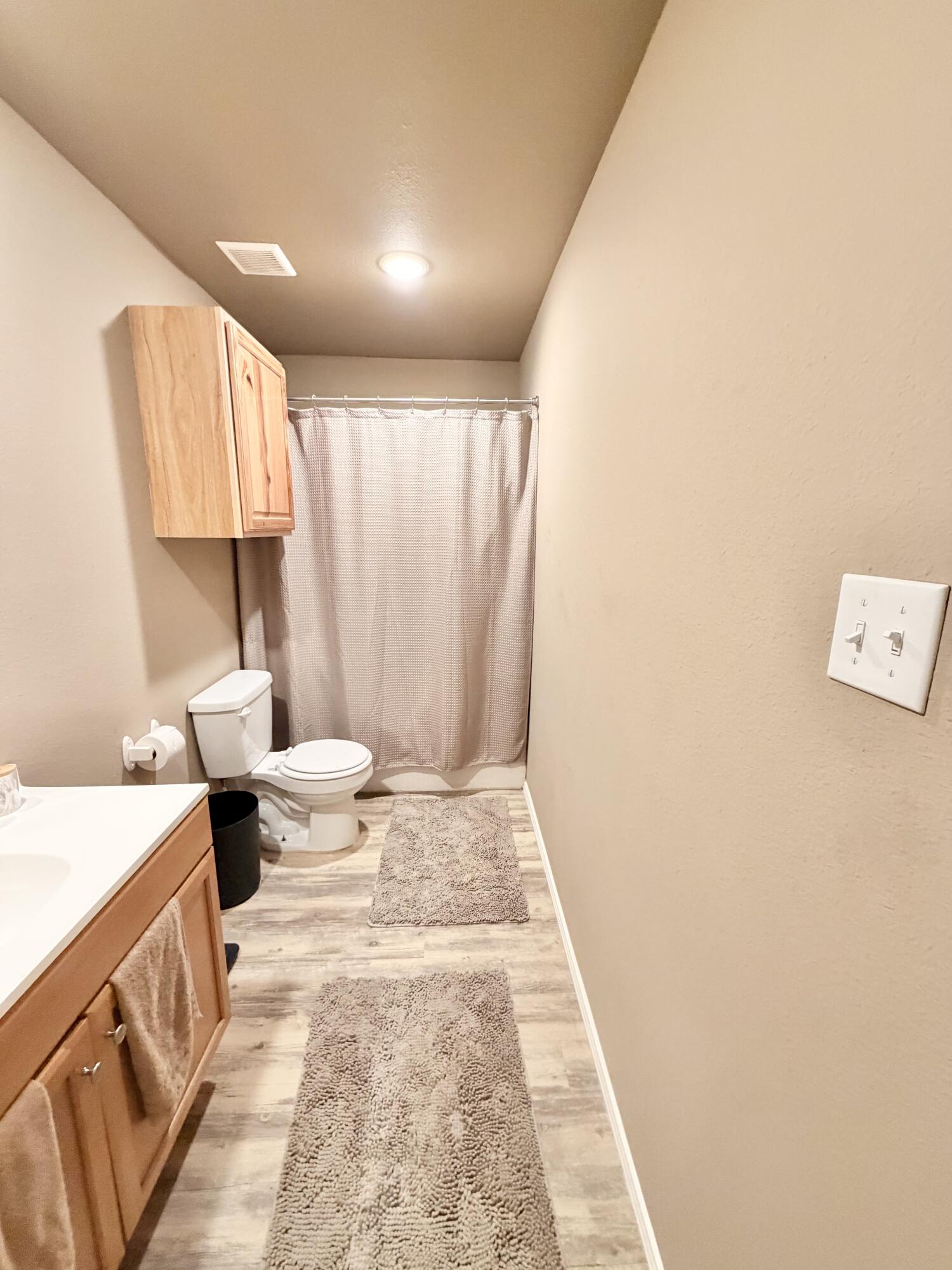 3211 East 5th Street Lubbock, TX 79403 - Photo 8 of 11 a bathroom with a sink toilet and shower