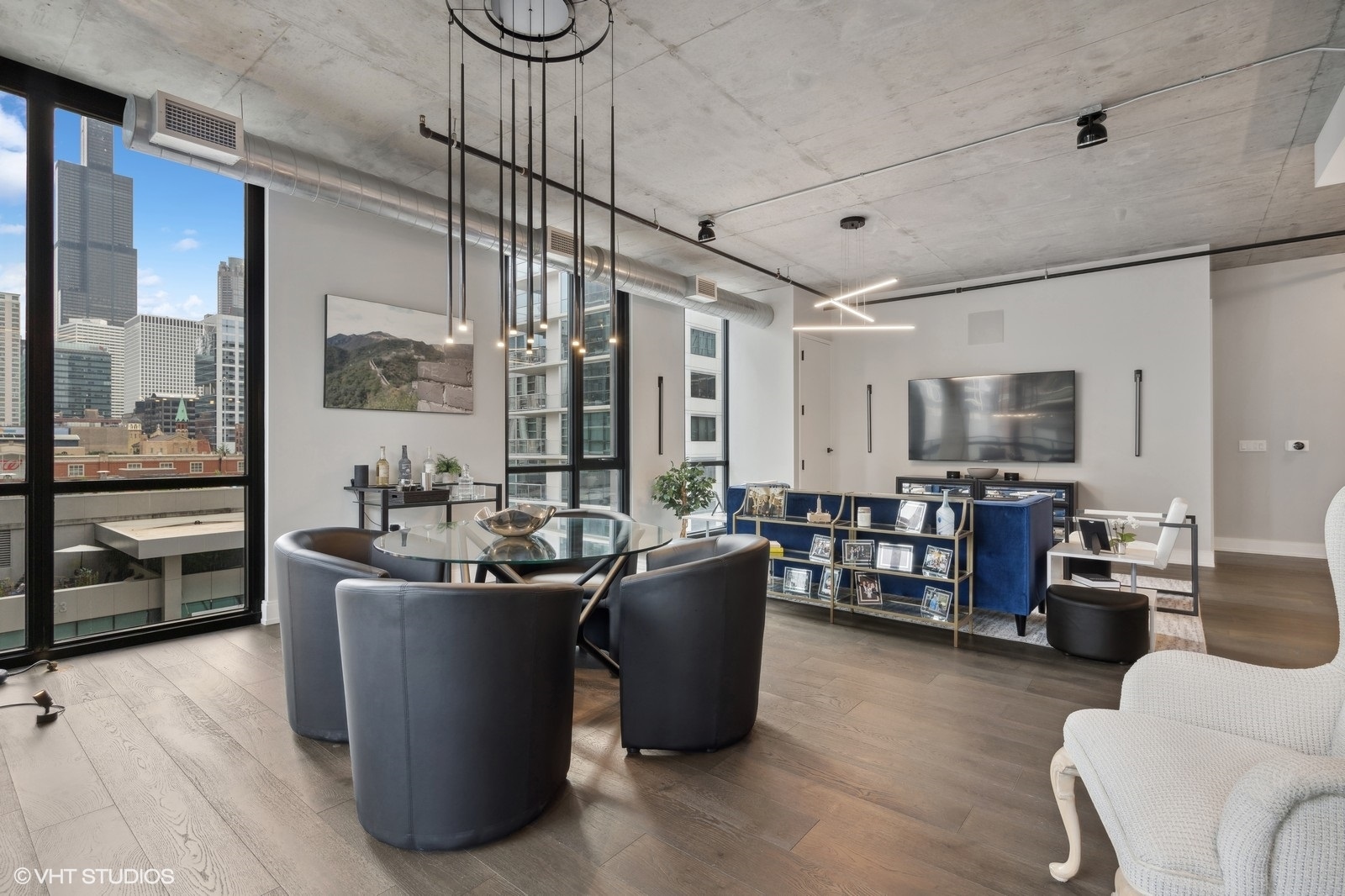 111 South Peoria Street, Unit 404 Chicago, IL 60607 - Photo 17 of 37 a living room with furniture a flat screen tv and kitchen view