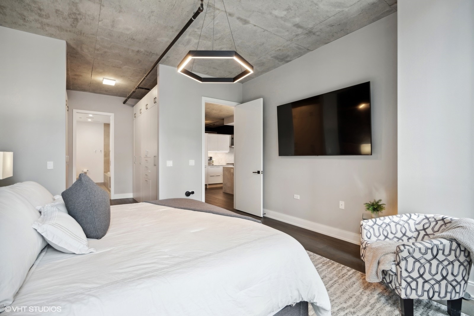 111 South Peoria Street, Unit 404 Chicago, IL 60607 - Photo 20 of 37 a bedroom with a bed and a flat screen tv