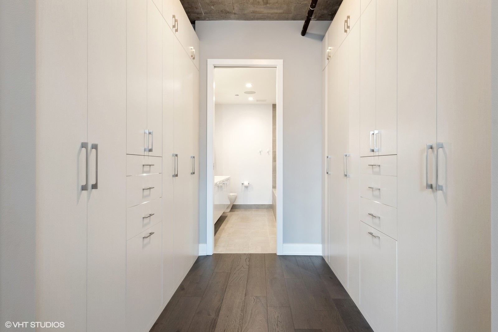 111 South Peoria Street, Unit 404 Chicago, IL 60607 - Photo 21 of 37 a view of a hallway with wooden floor and a bathroom