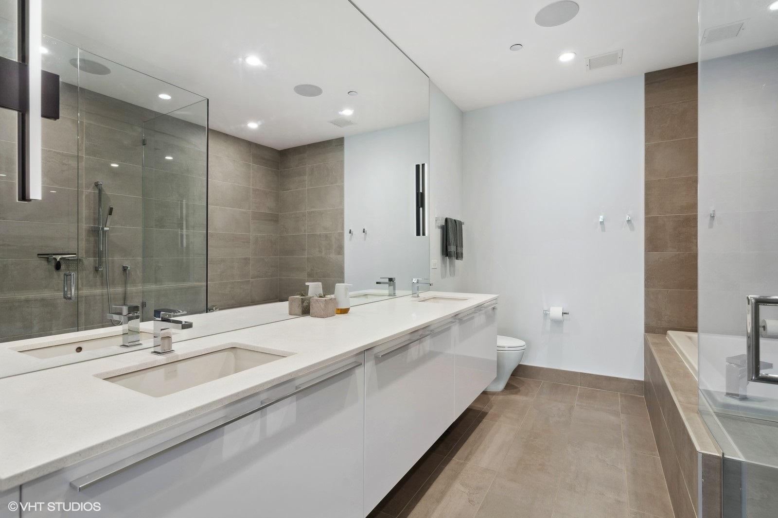111 South Peoria Street, Unit 404 Chicago, IL 60607 - Photo 22 of 37 a bathroom with a double vanity sink and mirror