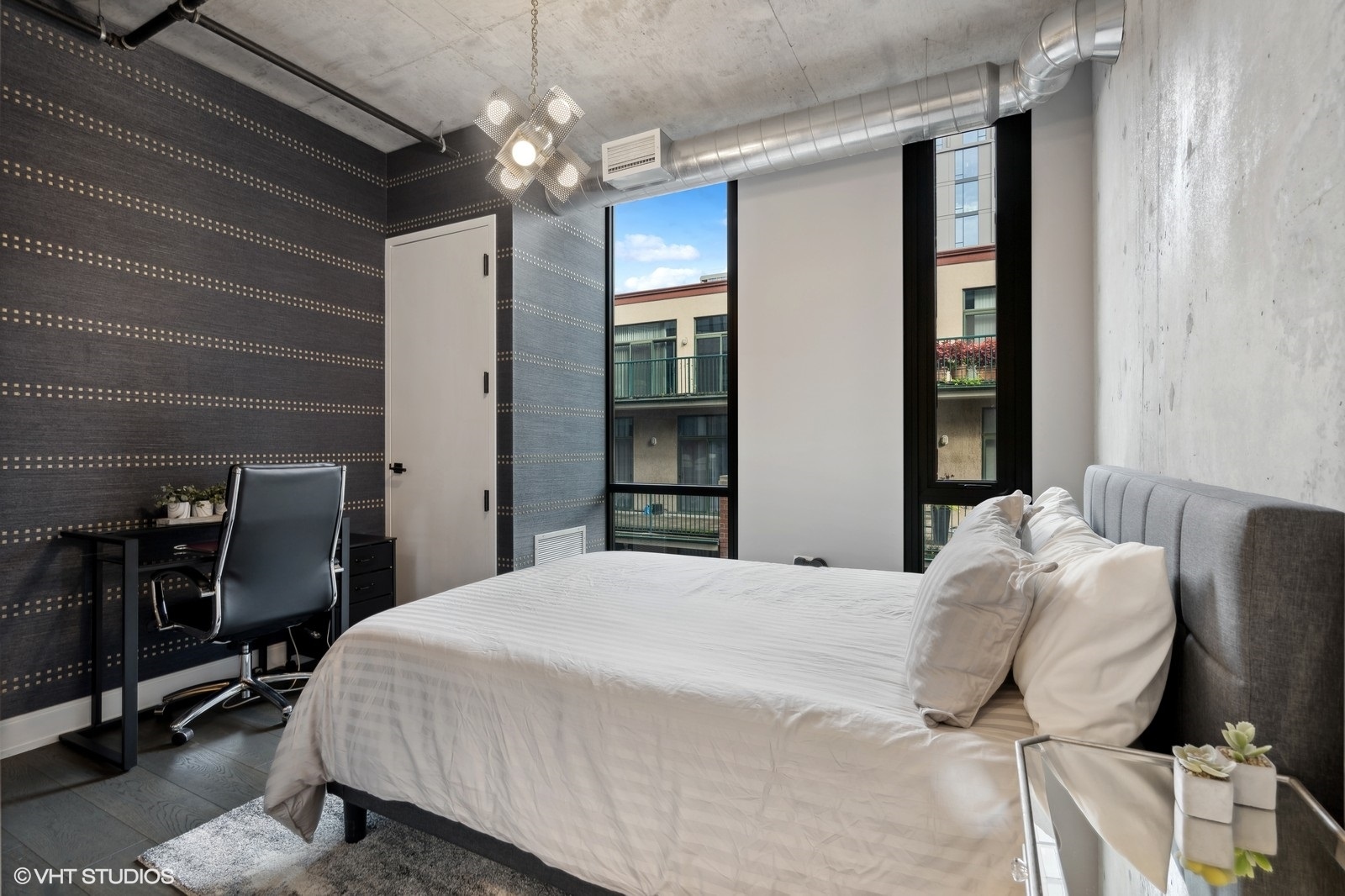 111 South Peoria Street, Unit 404 Chicago, IL 60607 - Photo 29 of 37 a bedroom with a bed and a chandelier