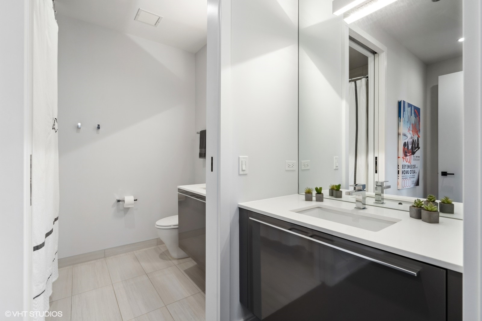 111 South Peoria Street, Unit 404 Chicago, IL 60607 - Photo 31 of 37 a bathroom with a sink a toilet a shower and a mirror