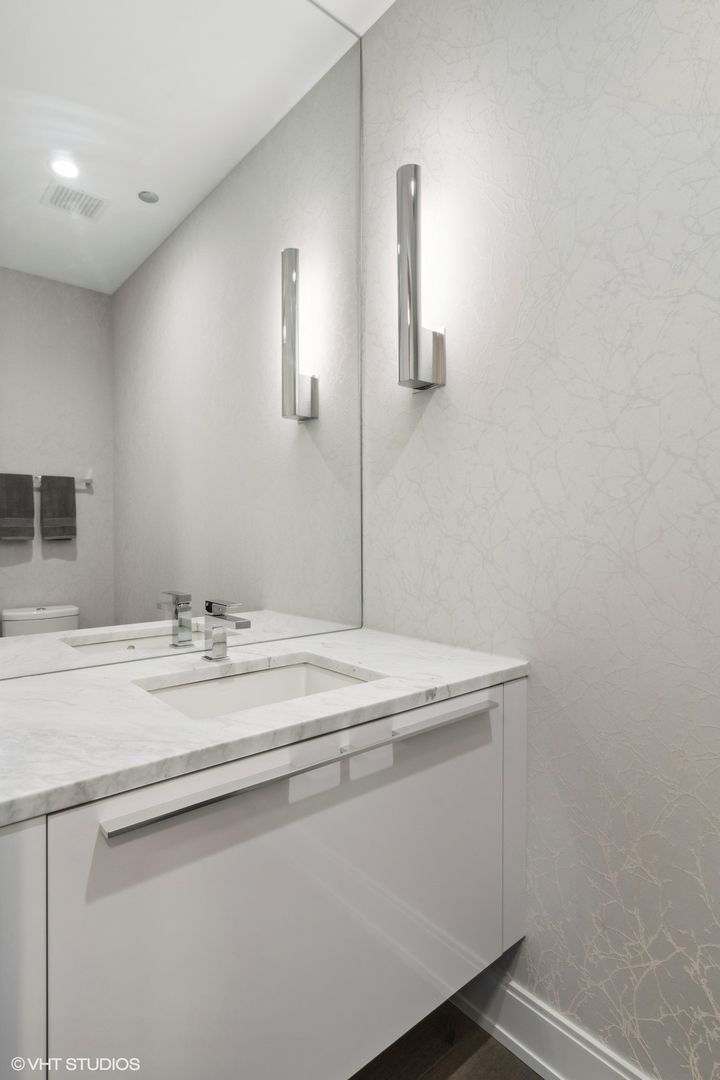 111 South Peoria Street, Unit 404 Chicago, IL 60607 - Photo 36 of 37 a bathroom with a sink and a mirror