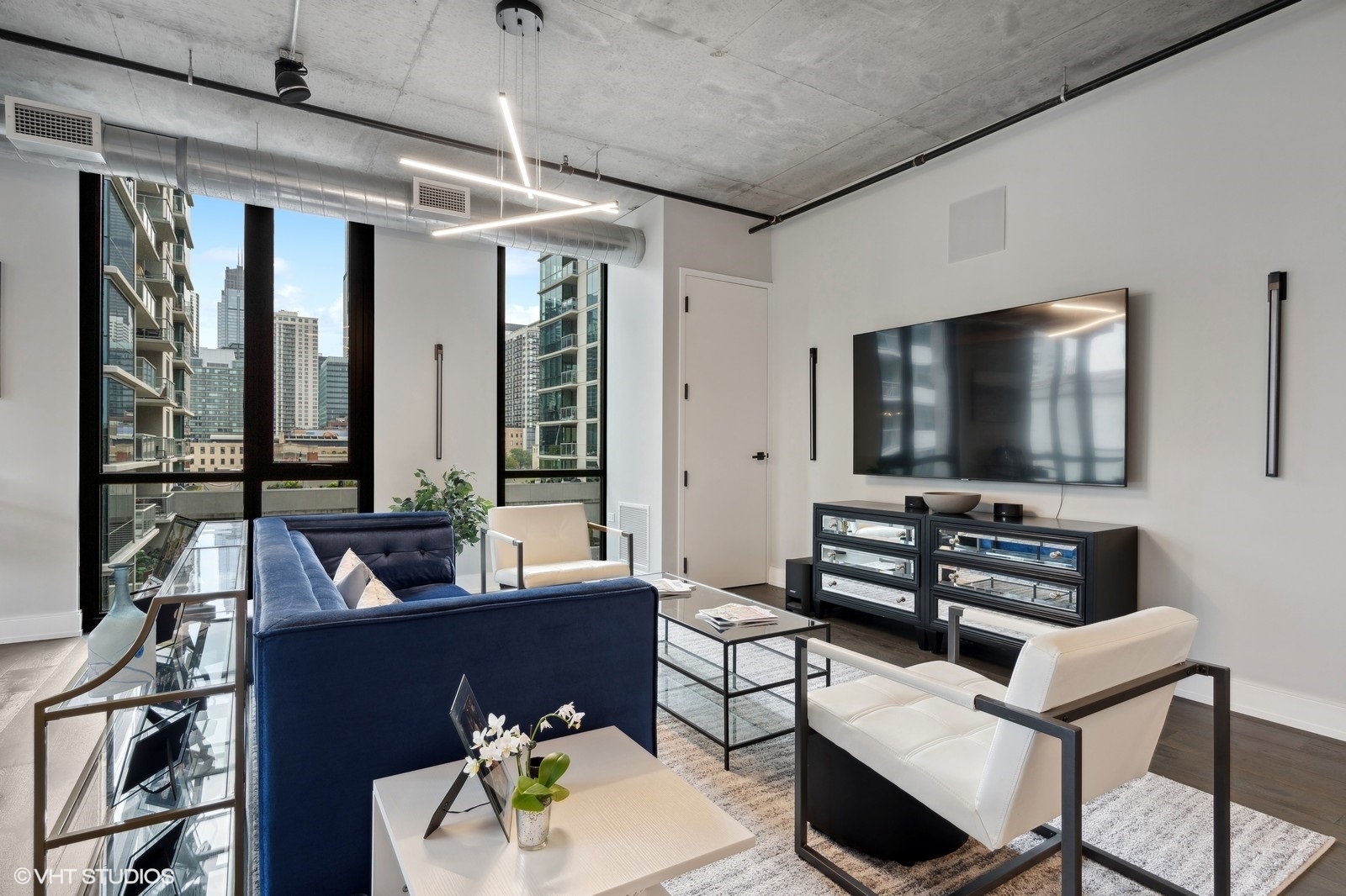 111 South Peoria Street, Unit 404 Chicago, IL 60607 - Photo 8 of 37 a living room with furniture and a flat screen tv