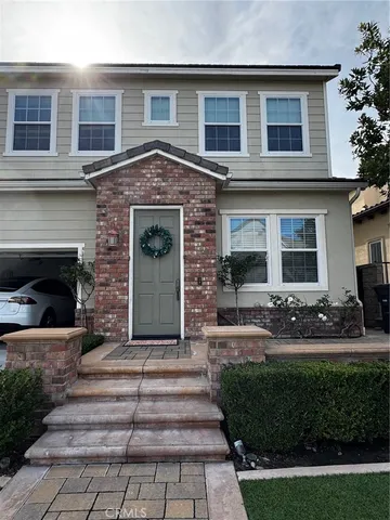 a front view of a house with yard and green space