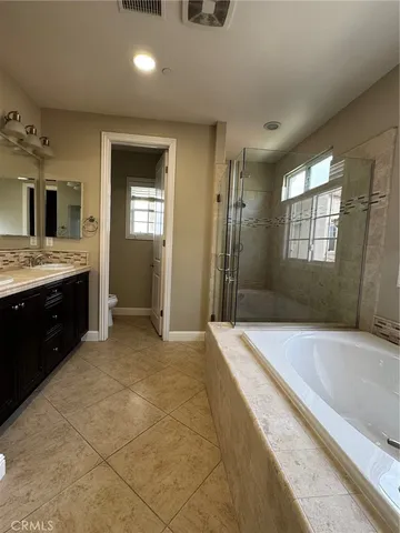 a bathroom with a tub a sink and a shower