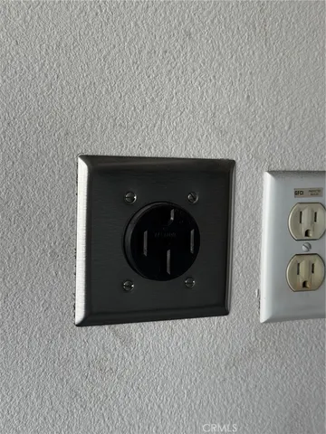 a kitchen with a refrigerator and wooden floor