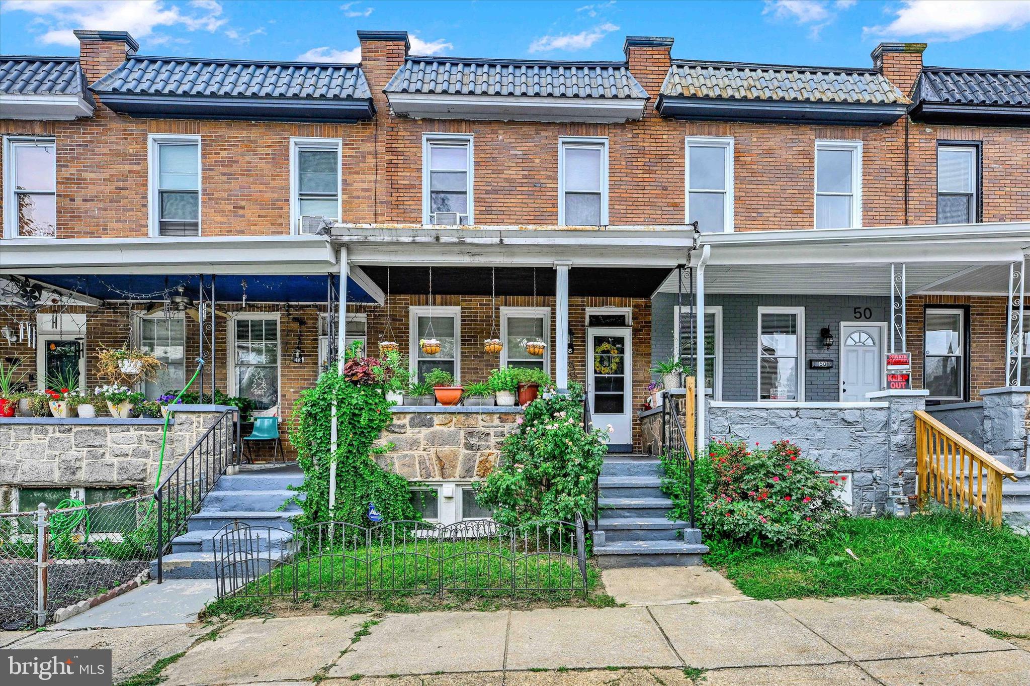 48 North Ellamont Street Baltimore, MD 21229 - Photo 2 of 26 front view of a brick house with a large windows