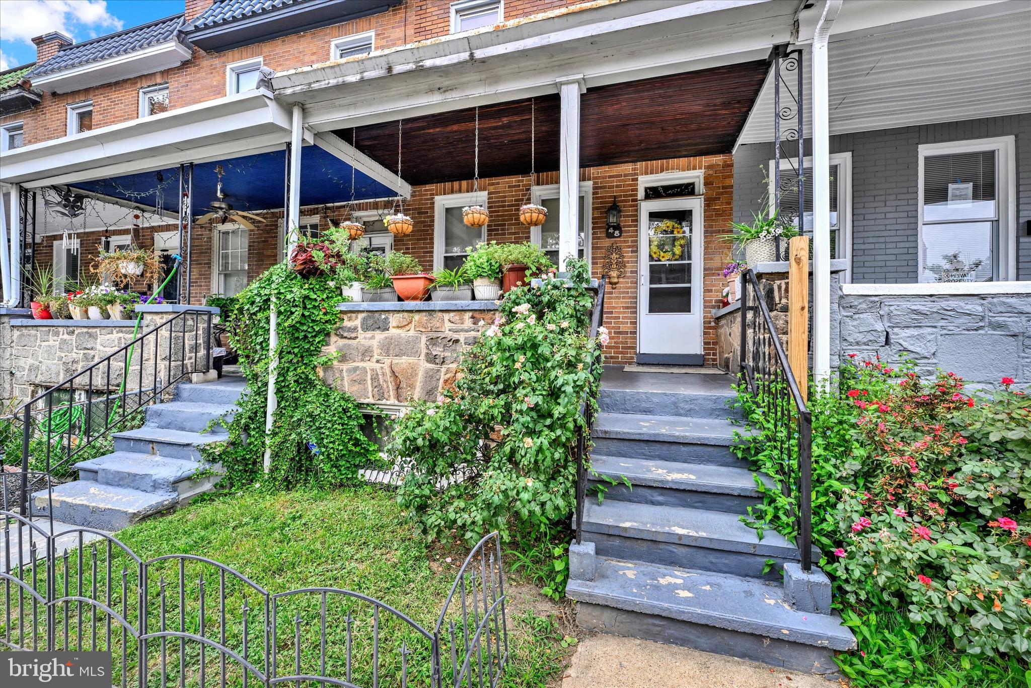 48 North Ellamont Street Baltimore, MD 21229 - Photo 4 of 26 a view of a house with potted plants