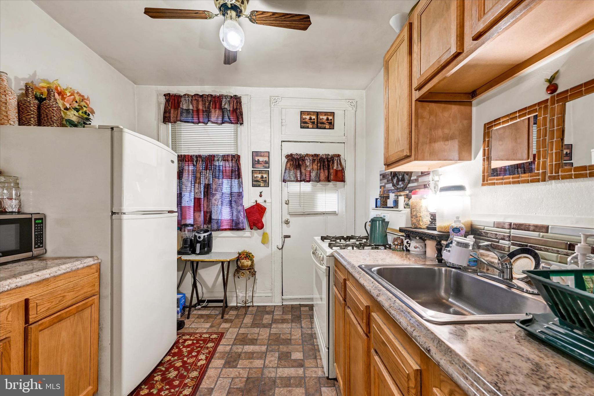 48 North Ellamont Street Baltimore, MD 21229 - Photo 10 of 26 a kitchen with a sink appliances and cabinets