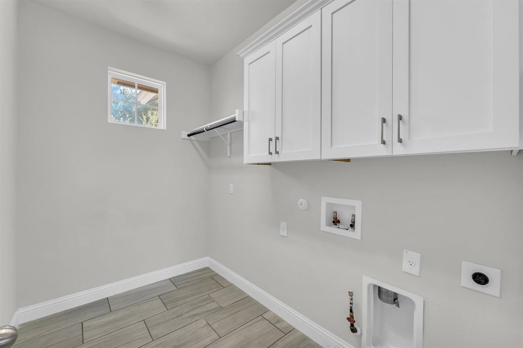 110 Magona Trail Georgetown, TX 78628 - Photo 26 of 38 Smartly designed utility space offers overhead cabinetry and durable tile flooring.