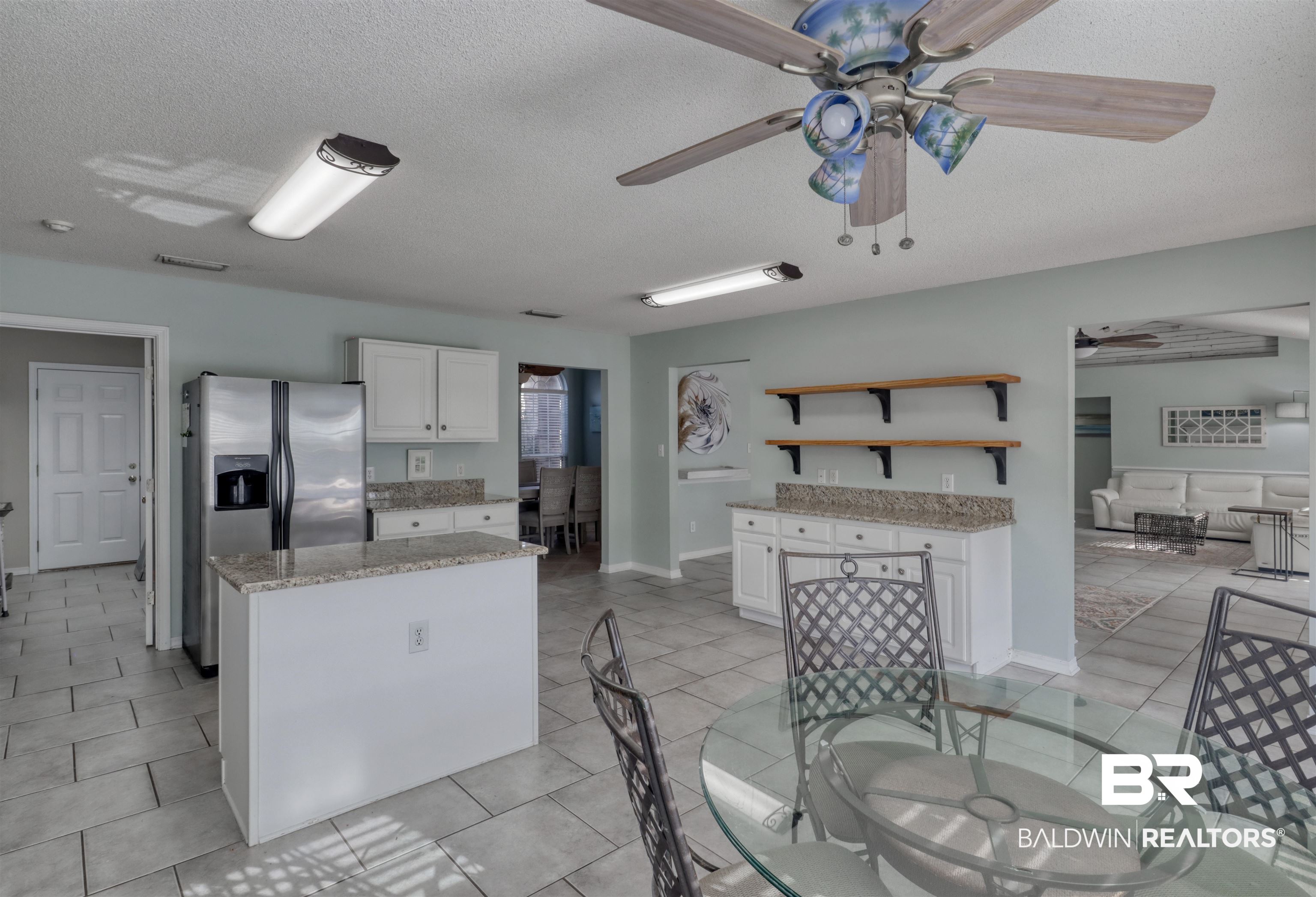 12893 Hunters Chase Foley, AL 36535 - Photo 22 of 42 Kitchen with white cabinets, stainless steel fridge, open shelves, and ceiling fan