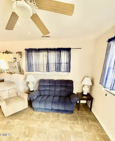 a living room with furniture rug and a window