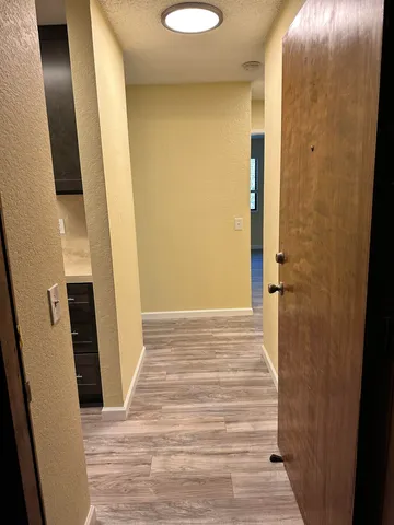 a big room with wooden floor and windows