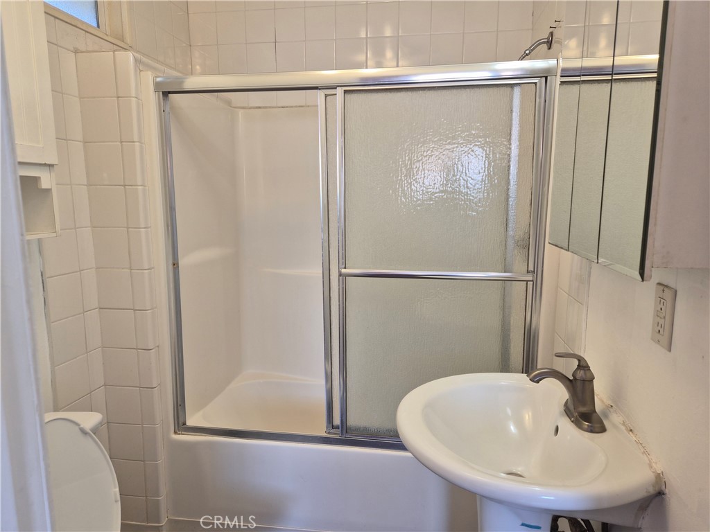 18749 Lemay Street Reseda, CA 91335 - Photo 13 of 17 a bathroom with a sink and a mirror