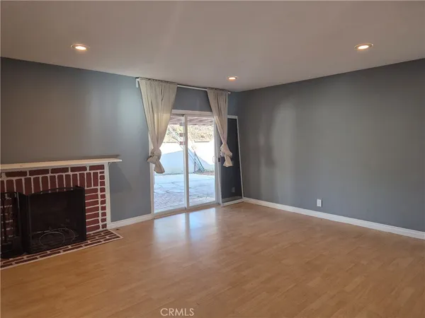 a view of an empty room with a fireplace