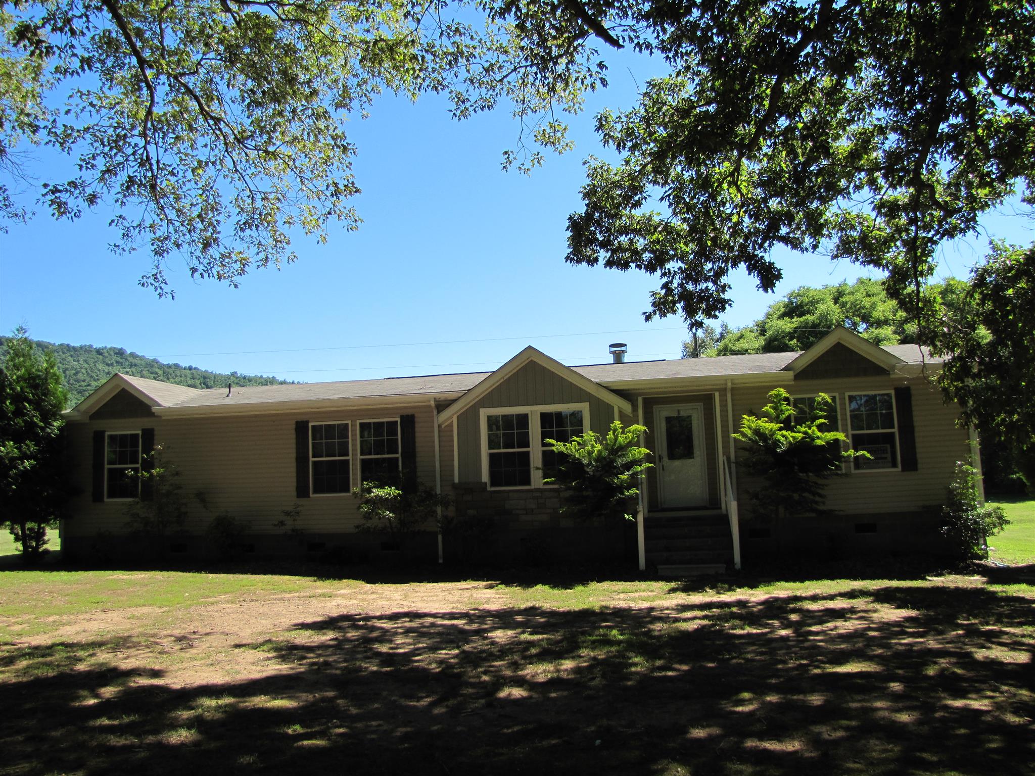 145 Womack Road Pelham, TN 37366 - Photo 1 of 19 a front view of a house with a yard