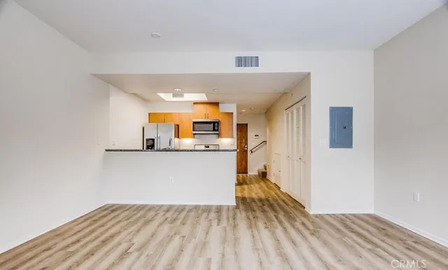 a view of a kitchen with a sink and a refrigerator