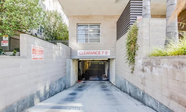 a view of a hallway with a glass door and shower