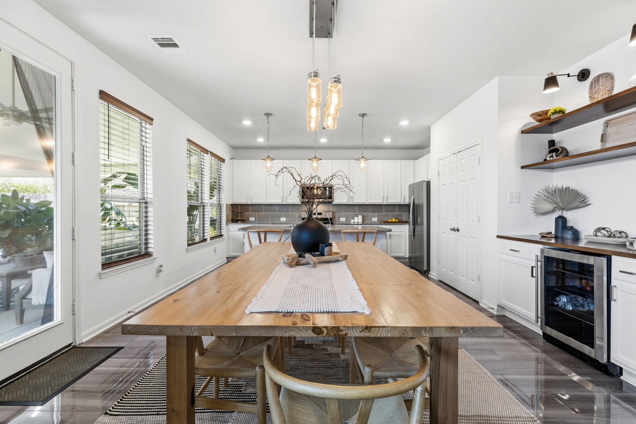 5127 Avondale Rise Street Katy, TX 77493 - Photo 18 of 47 a kitchen with kitchen island a stove a table and chairs in it