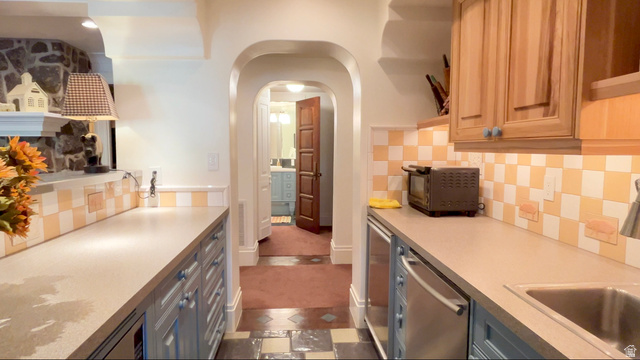 426 West Center Street Parowan, UT 84761 - Photo 68 of 107 Galley kitchen featuring light blue base cabinetry, natural wood-finish upper cabinetry, and a checkerboard tile backsplash