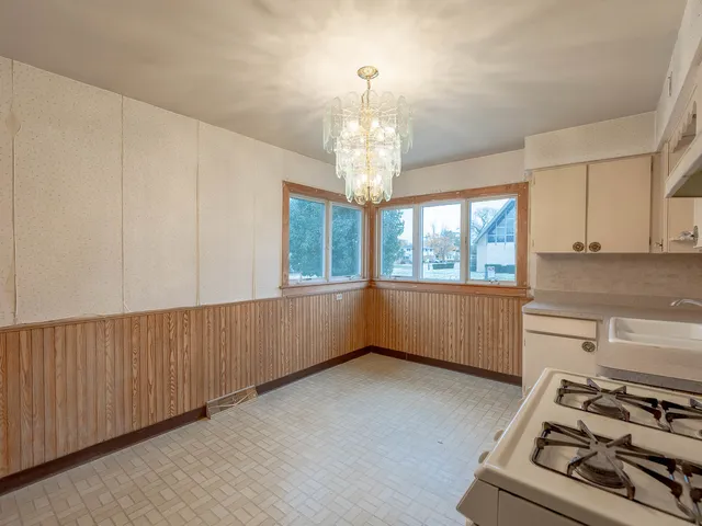 a kitchen with stainless steel appliances wooden cabinets and a stove top oven
