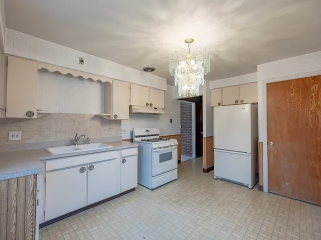 a kitchen with stainless steel appliances a refrigerator sink and microwave