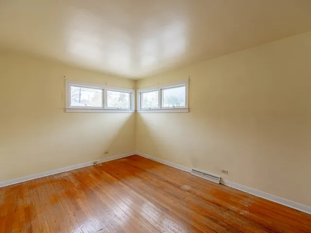 a view of a room with wooden floor and fan