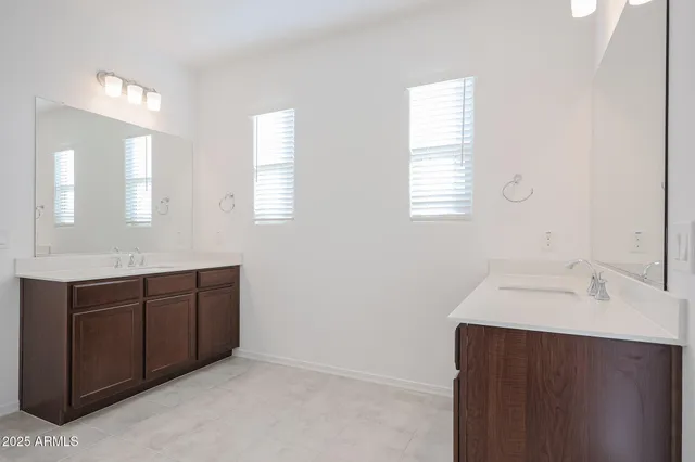 a bathroom with a sink vanity and mirror