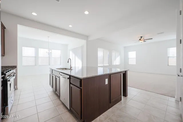a kitchen with stainless steel appliances granite countertop a stove and a sink