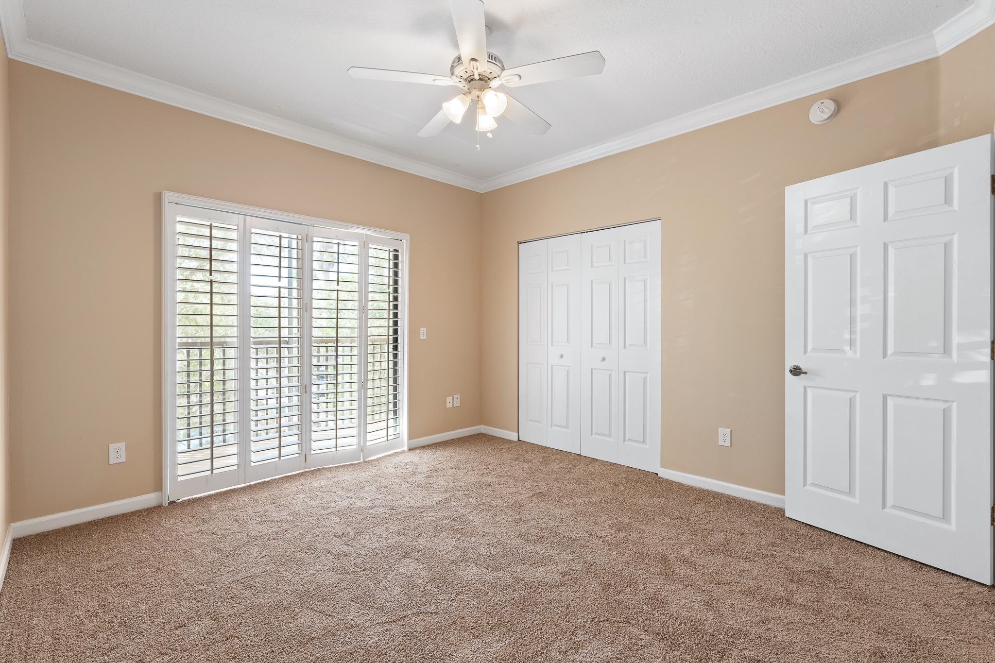3425 Haley Pointe Road St. Augustine, FL 32084 - Photo 41 of 71 Unfurnished bedroom with ornamental molding, carpet flooring, ceiling fan, a closet, and access to exterior