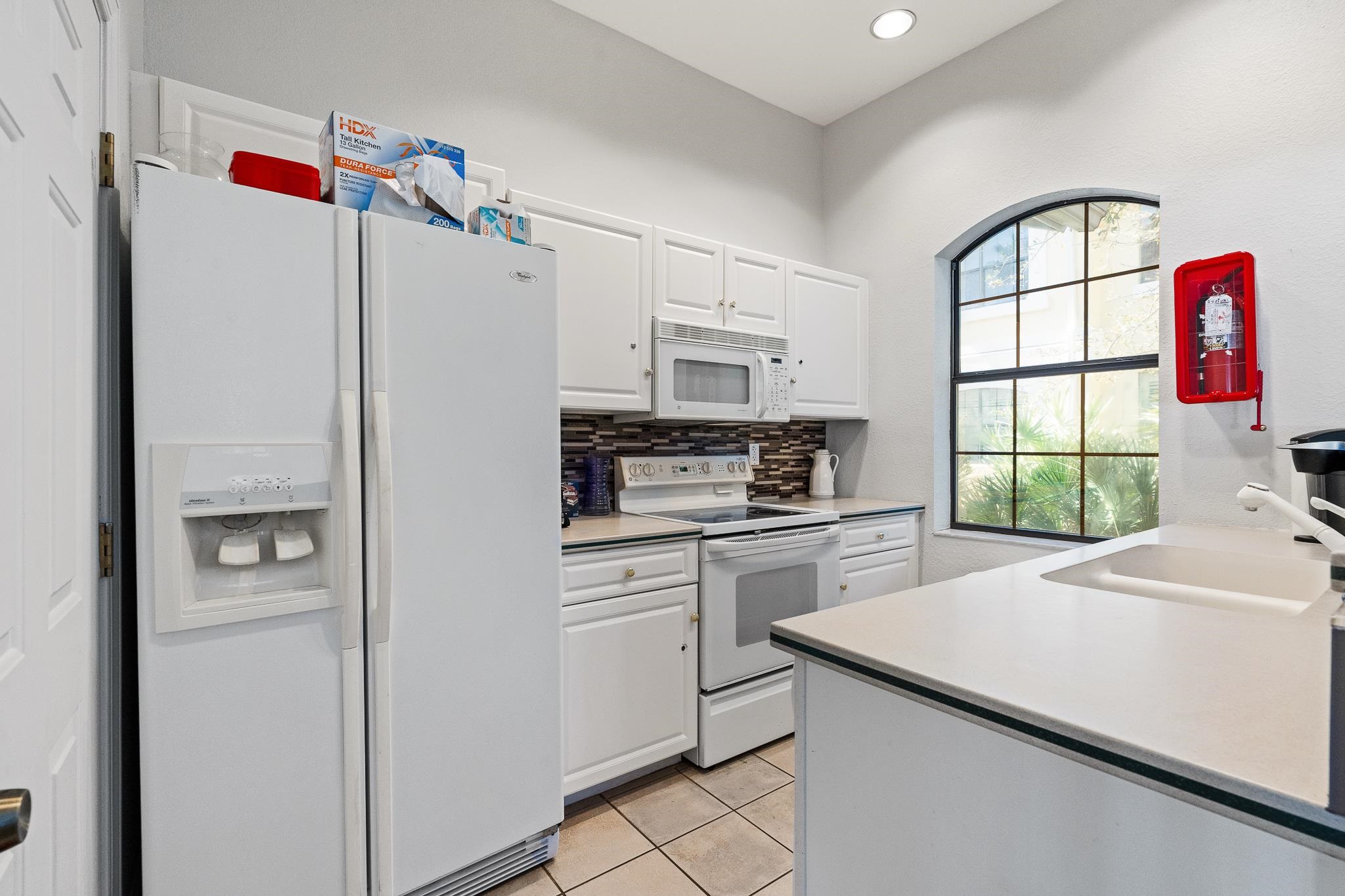 3425 Haley Pointe Road St. Augustine, FL 32084 - Photo 69 of 71 a kitchen with a refrigerator a stove a sink and a window
