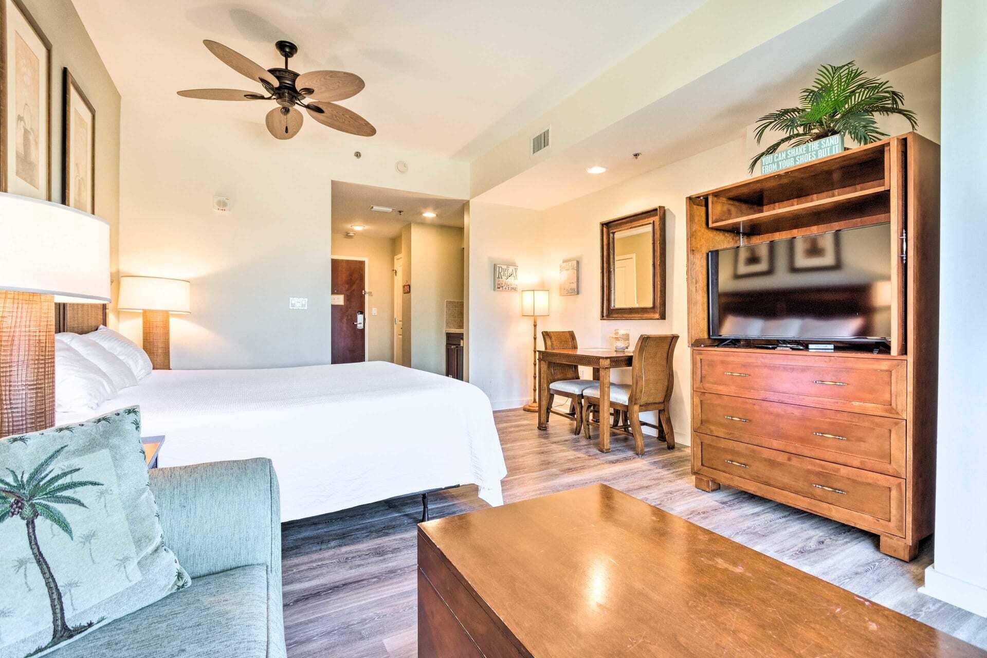 5000 South Sandestin Boulevard, Unit 6512 Miramar Beach, FL 32550 - Photo 2 of 29 a spacious bedroom with a bed a dresser and potted plants