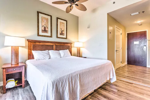 a bedroom with a bed and a chandelier