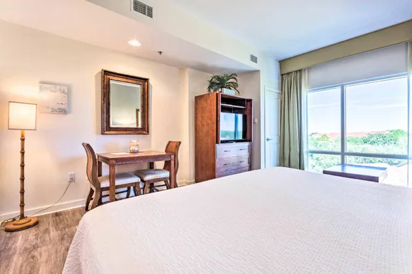 a bedroom with a bed table and chair