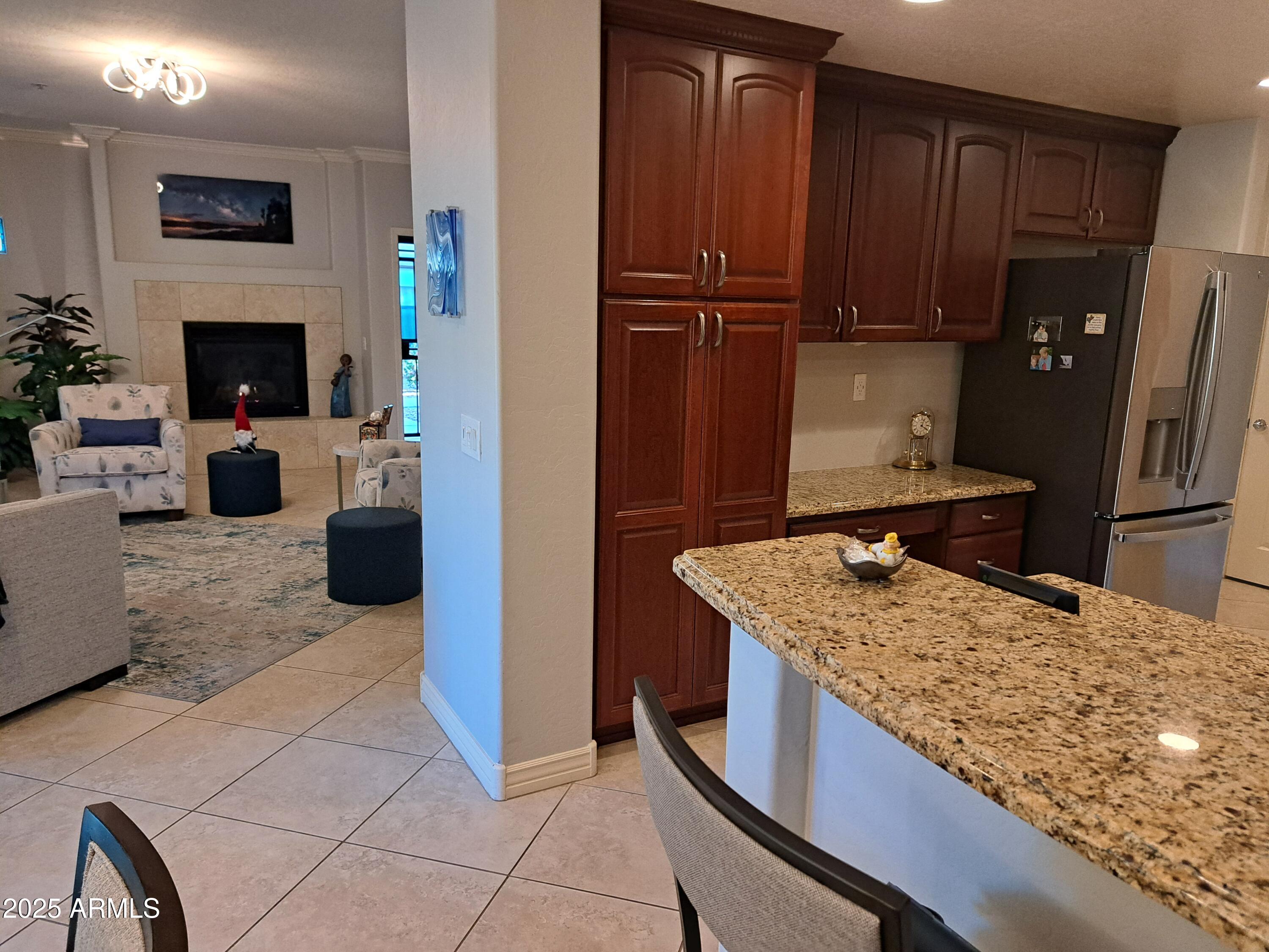 21320 North 56th Street, Unit 1163 Phoenix, AZ 85054 - Photo 11 of 48 a kitchen with a stove a refrigerator and a wooden cabinets