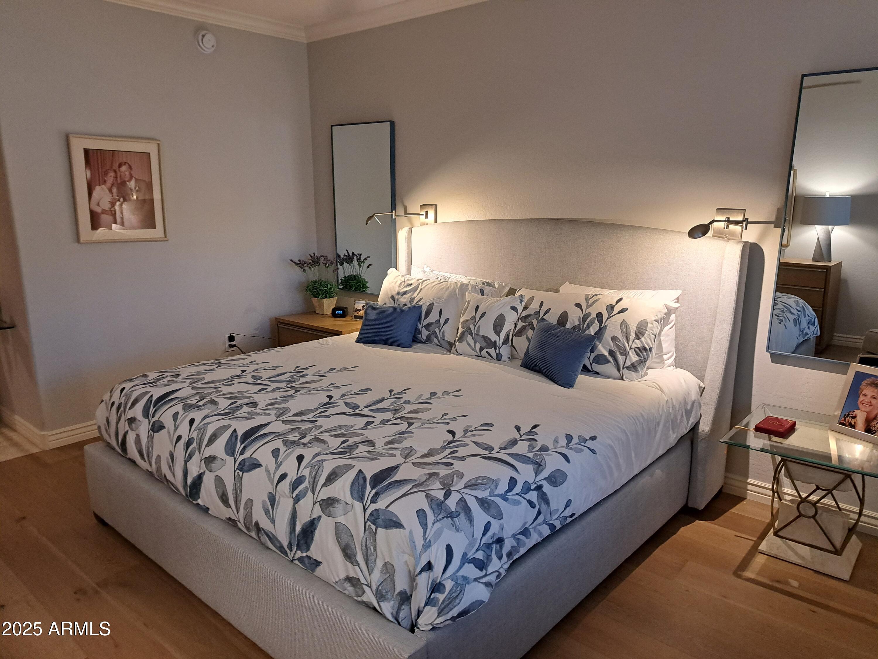 21320 North 56th Street, Unit 1163 Phoenix, AZ 85054 - Photo 18 of 48 a large bed sitting in a bedroom next to a lamp