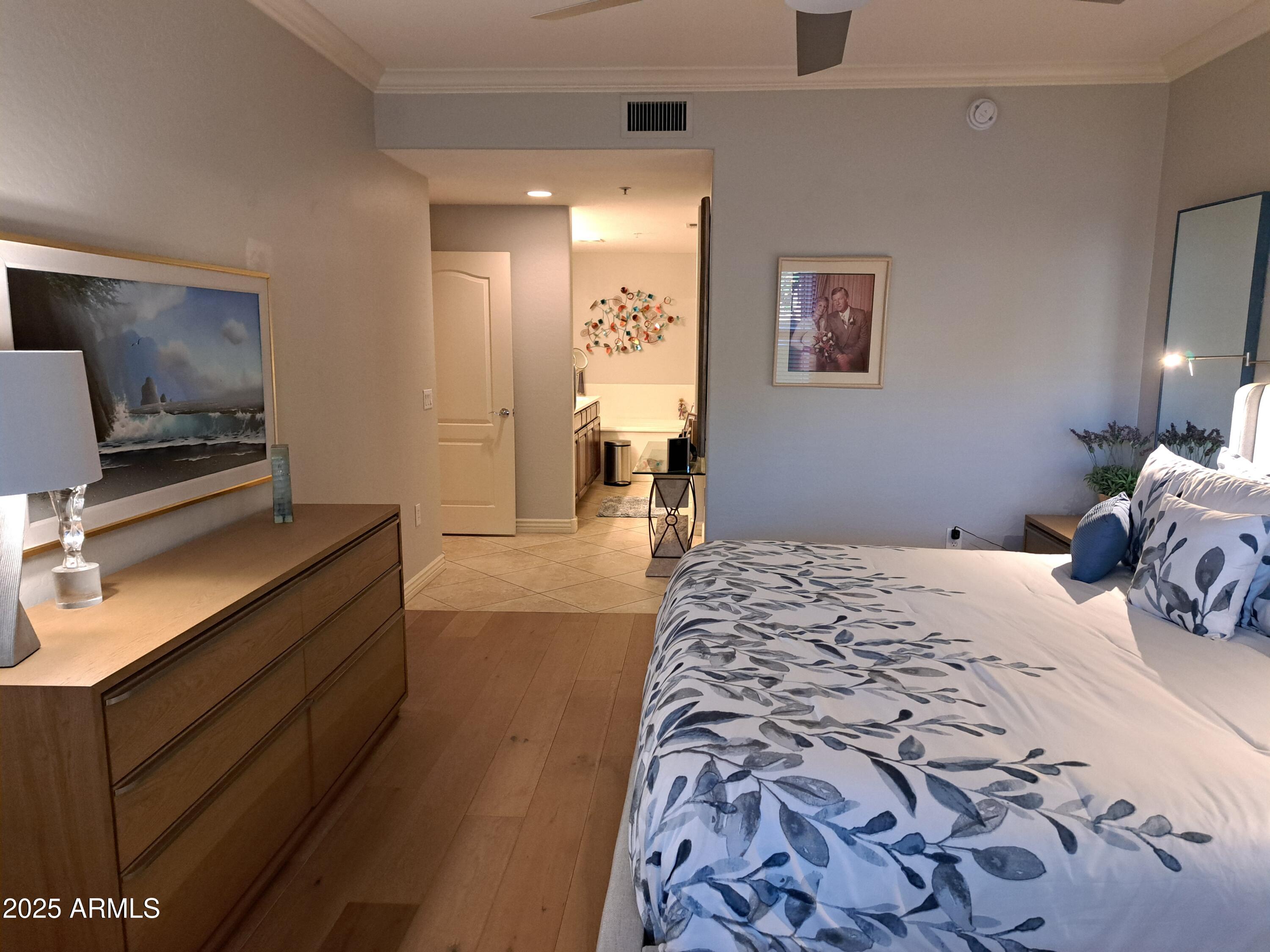 21320 North 56th Street, Unit 1163 Phoenix, AZ 85054 - Photo 19 of 48 a bedroom with a bed and a flat screen tv