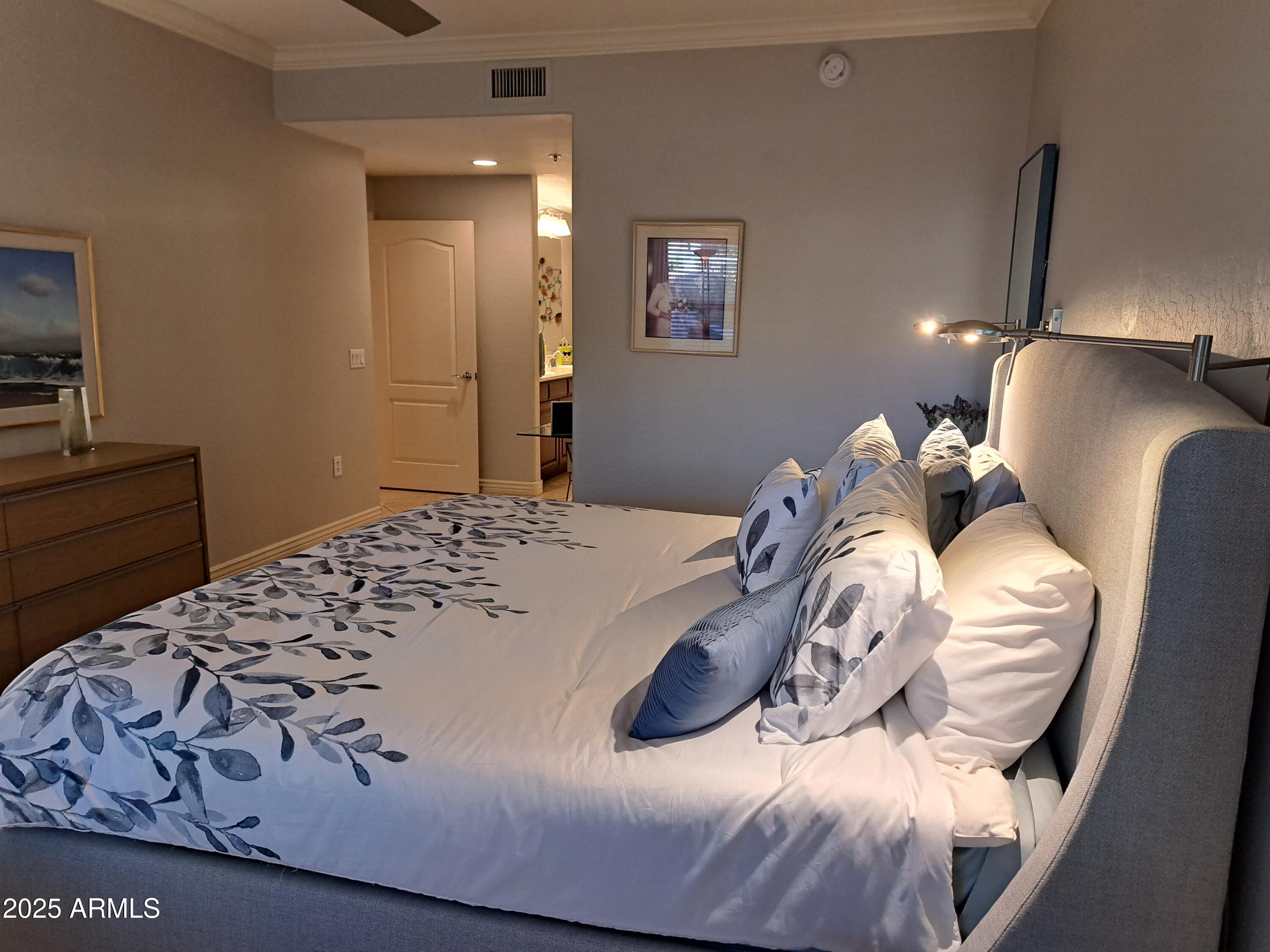 21320 North 56th Street, Unit 1163 Phoenix, AZ 85054 - Photo 20 of 48 a bedroom with a bed and lamp