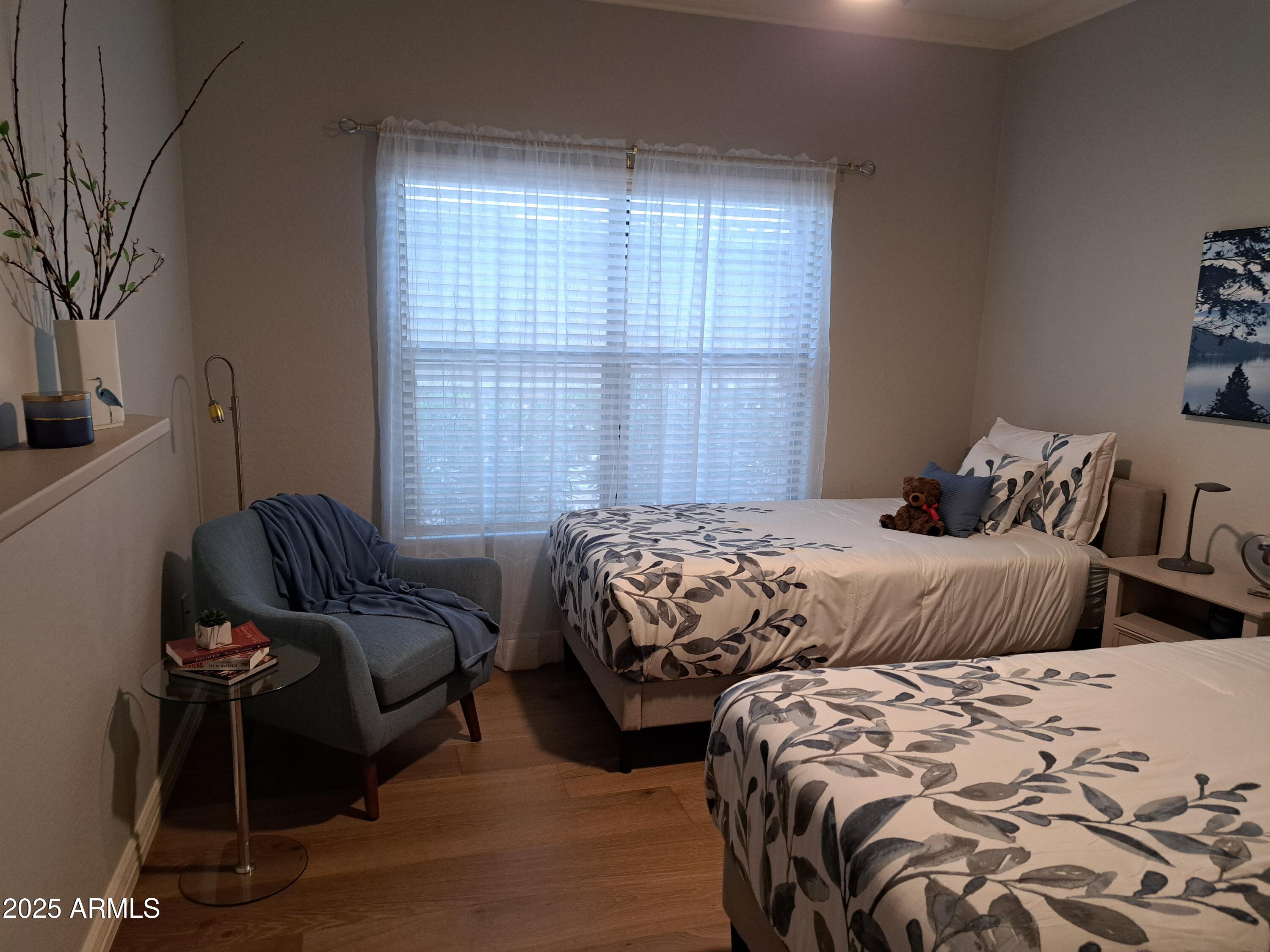 21320 North 56th Street, Unit 1163 Phoenix, AZ 85054 - Photo 31 of 48 a bedroom with two beds and a chair