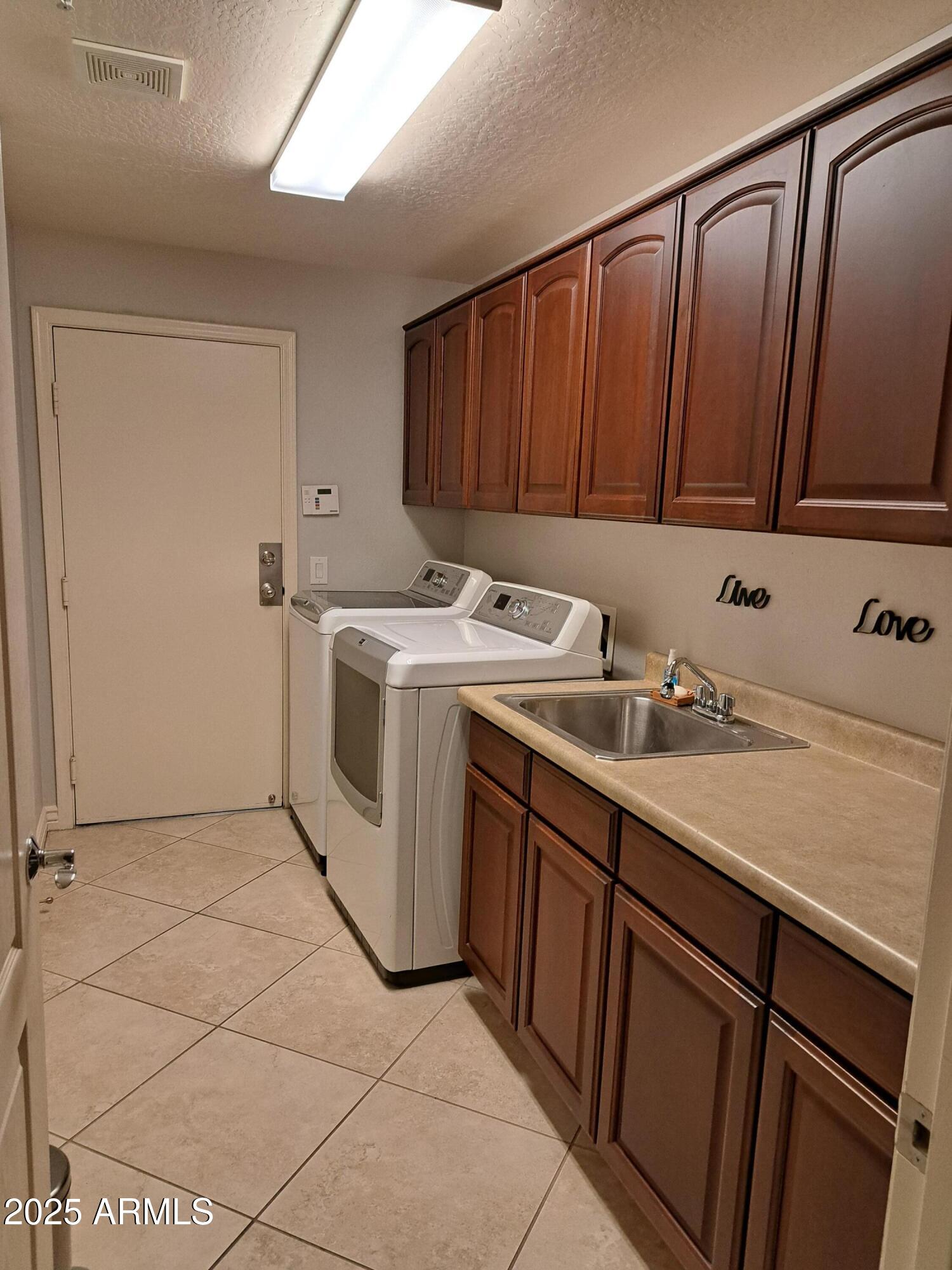 21320 North 56th Street, Unit 1163 Phoenix, AZ 85054 - Photo 36 of 48 a utility room with a sink washer and dryer