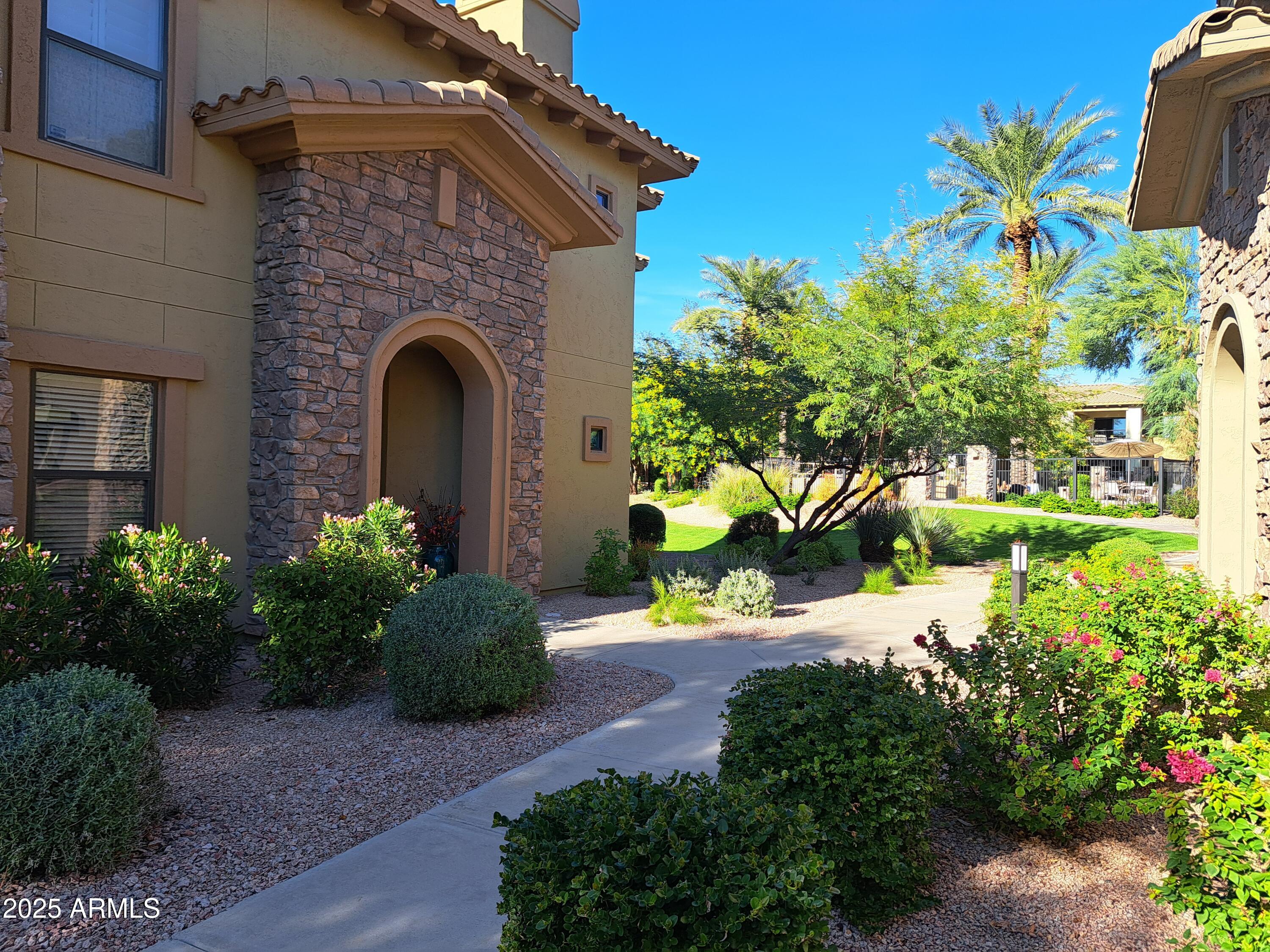 21320 North 56th Street, Unit 1163 Phoenix, AZ 85054 - Photo 38 of 48 a front view of a house with a yard