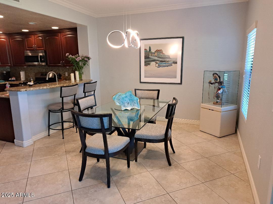 21320 North 56th Street, Unit 1163 Phoenix, AZ 85054 - Photo 8 of 48 a dining room with furniture and a kitchen view
